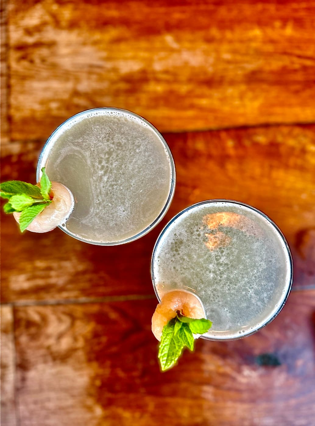 Two of Banana Tree Oxford's 2-for-1 cocktails, garnished with lychee and mint