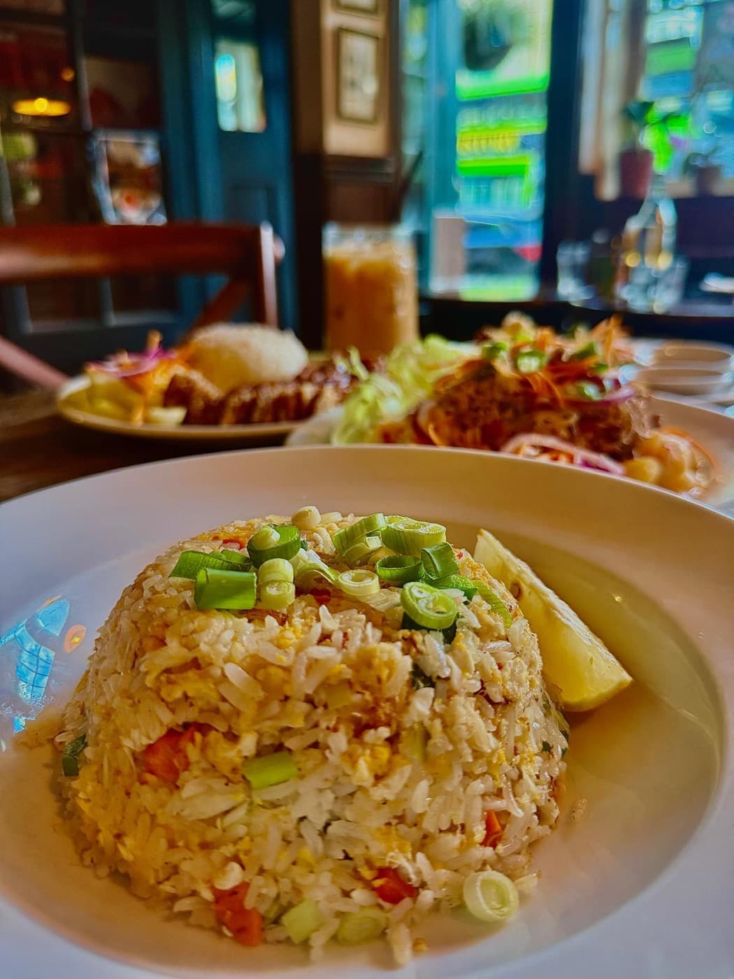 Crab meat fried rice at The Old Tom Oxford, topped with spring onion and served with a wedge of lime