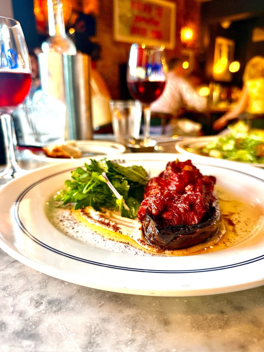Imam bayildi: aubergine stuffed with spiced tomato, with herb salad and tahini dressing