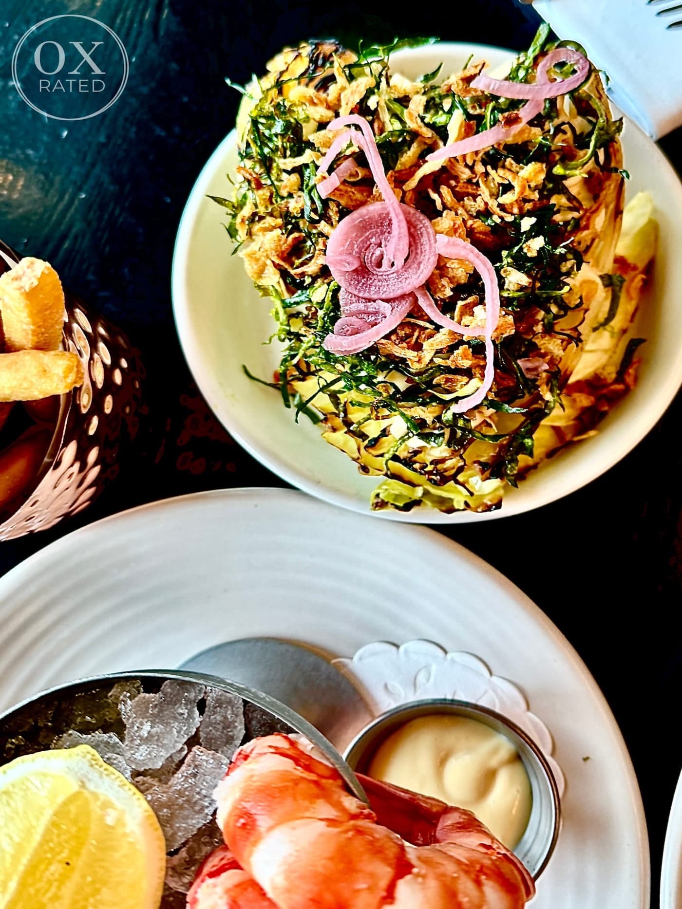 Chargrilled hispi cabbage with pickled onion, and fries on the side