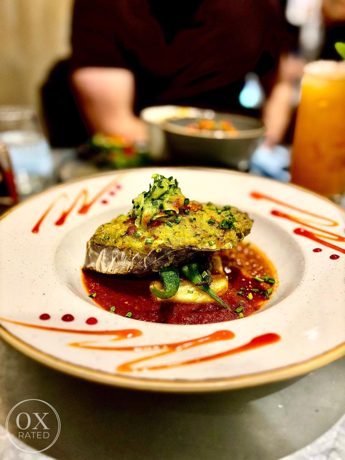 Kingfish steak with a herb crust on a tomato sauce